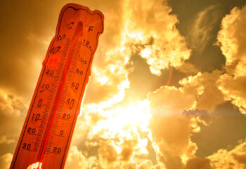 Melting street thermometer against bright summer sun.High temperature.Summer heat.Concept of global warming