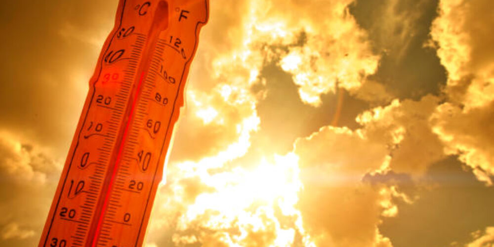 Melting street thermometer against bright summer sun.High temperature.Summer heat.Concept of global warming